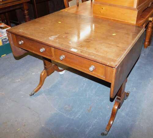 A mahogany sofa table, the dropleaf top above two frieze drawers, raised on square supports with...