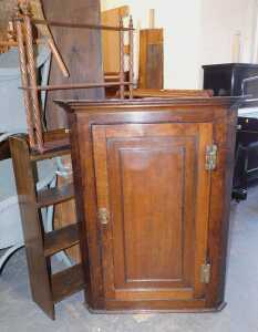A George III oak hanging corner cabinet, together with an oak bookcase and a three tier hanging...