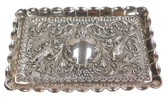 A dressing table tray, possibly of Jewish origin, embossed with birds, a mask, flowers and...
