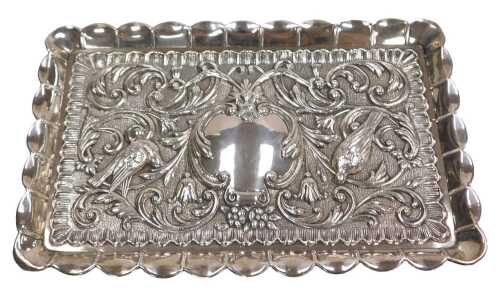 A dressing table tray, possibly of Jewish origin, embossed with birds, a mask, flowers and...