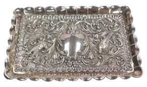 A dressing table tray, possibly of Jewish origin, embossed with birds, a mask, flowers and...