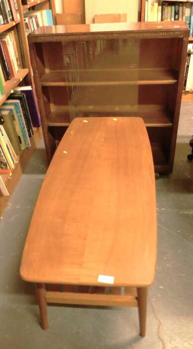 An oak coffee table, the rectangular top with a rounded edge above a slatted undertier, raised...