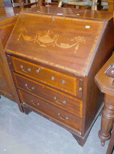 An Edwardian Sheraton Revival mahogany and inlaid bureau, the urn, bow and swag decorated fall...