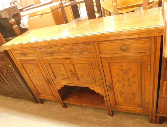 A late Victorian mahogany sideboard, the top with three drawers above panelled cupboards, with a...