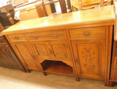 A late Victorian mahogany sideboard, the top with three drawers above panelled cupboards, with a...
