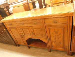 A late Victorian mahogany sideboard, the top with three drawers above panelled cupboards, with a...