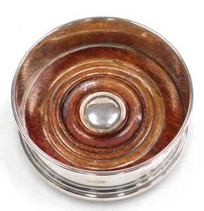 An Elizabeth II coaster, with a turned mahogany base, London 2001, 2.59oz all in, 9cm wide. - 2
