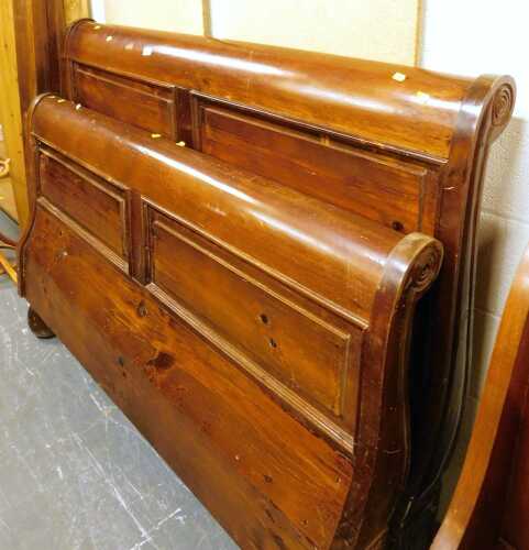A hardwood double sleigh bed, with headboard, footboard, side rails and base.