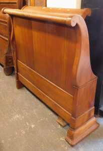 A hardwood single sleigh bed, with headboard, footboard and side rails.