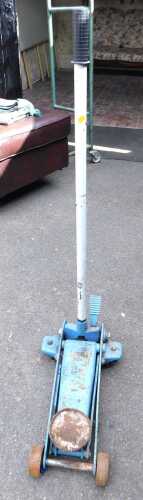 A blue hydraulic trolley jack.