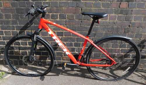 A Trek Dual Sport mountain bike, in red trim.