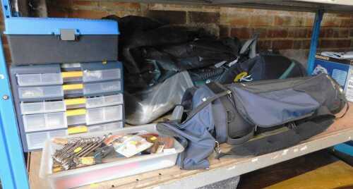 Two golf bags, containing various golf clubs, together with a plastic multi sectional unit...