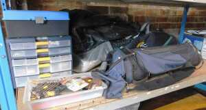 Two golf bags, containing various golf clubs, together with a plastic multi sectional unit...