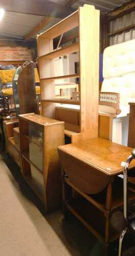 A group of furniture, to include a pine open bookcase, mirror back dressing table, bookcase,...