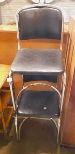 A pair of chrome framed dining chairs, each with a black leatherette seat and back. 
The...