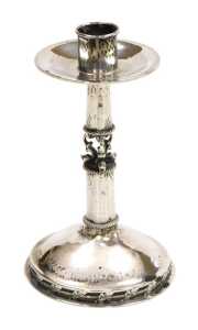 A George V Arts & Crafts silver candlestick, with hammered decoration, the mid shaft formed as...