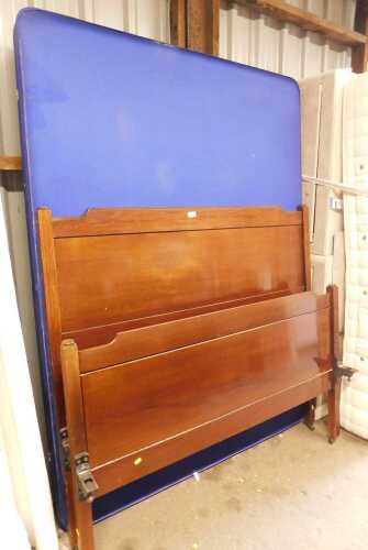 A mahogany double bed, comprising headboard, footboard and bed base.