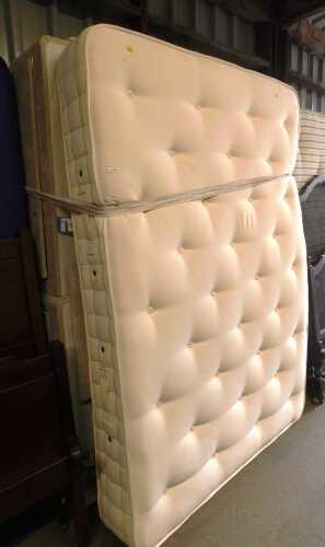 A small double bed, comprising a mattress and divan bed base.