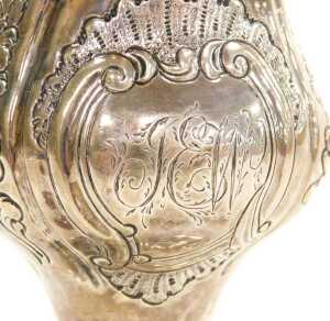 A George III silver cream jug, of ogee form, with a double scroll handle, the body embossed with... - 2