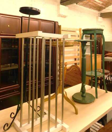 A group of furniture, including a gilt painted tripod table, a wrought metal candle stand, green...