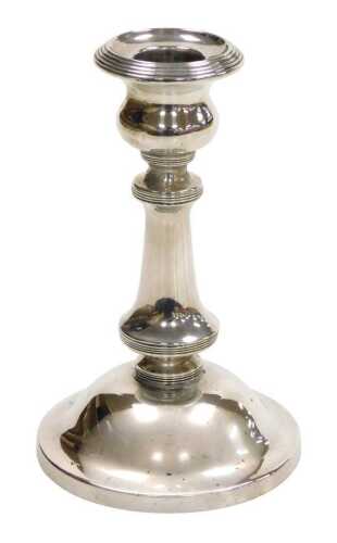 An Edward VII loaded silver candlestick, with reeded banding, Birmingham 1907, 11.29oz all in,...