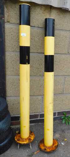 V - Two red and black cast metal bollards, 124cm high.
