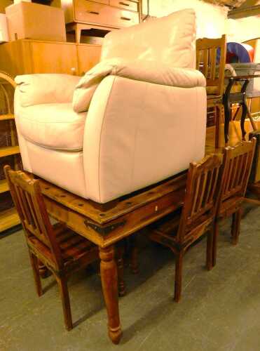 A mango wood dining table, raised on turned legs, together with six chairs and a cream leather...