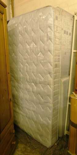 V - A twin base double divan style bed, with mattress.