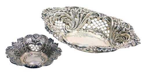An Edward VII silver sweetmeat basket, of oval form, with pierced and embossed decoration of...