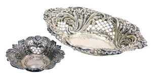 An Edward VII silver sweetmeat basket, of oval form, with pierced and embossed decoration of...