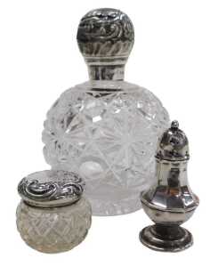 A Victorian cut glass scent bottle, with a silver mount and screw lid, embossed with flowers and...