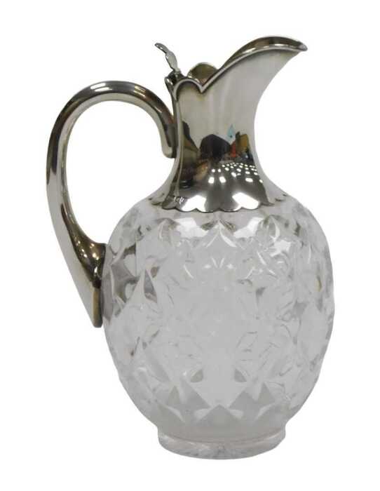 A Victorian cut glass and silver mounted claret jug, with a silver handle and hinged lid,...