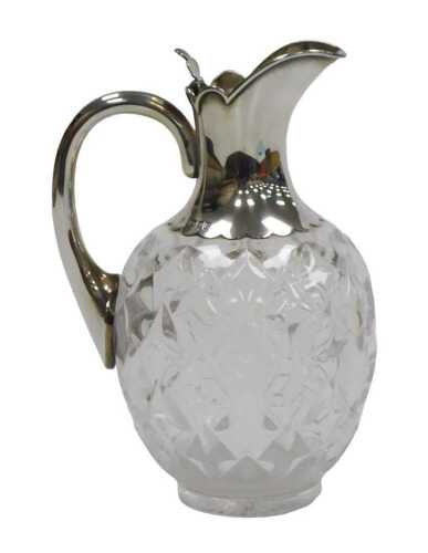 A Victorian cut glass and silver mounted claret jug, with a silver handle and hinged lid,...