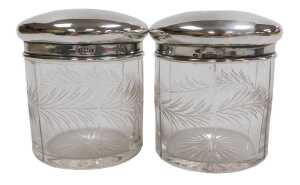 Two George V cut glass and silver lidded toilet jars, engraved with a band of leaves, Birmingham...