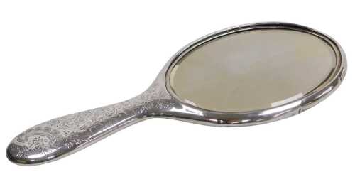 An Edward VII silver backed hand mirror, with engraved floral, foliate and C scroll decoration,...