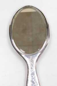 An Edward VII silver backed hand mirror, with engraved floral, foliate and C scroll decoration,... - 2