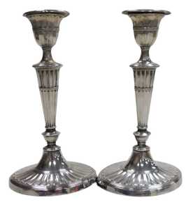 A pair of George V Adams style loaded silver candlesticks, of fluted form, raised on outswept...