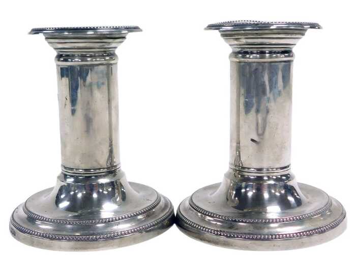 A pair of Edward VII loaded silver candlesticks, with beaded decoration, London 1907, 15.90oz...