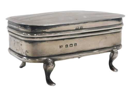 A George V silver dressing table box, of oblong form, the hinged lid with engine turned...