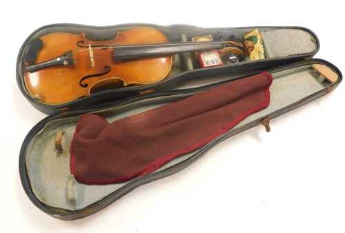An early 20thC Czechoslovakian violin, with a single piece back, cased and outer bagged.