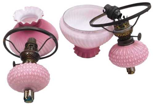 A pair of late 19thC pink opaline glass oil lamp fitments, with honeycomb moulded reservoirs and...