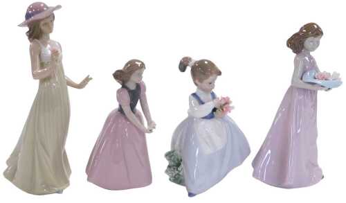 Four Nao porcelain figures of girls, each holding flowers.