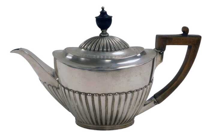 An Edward VII silver teapot, of semi fluted form, Goldsmiths & Silversmiths Company, London 1901,...