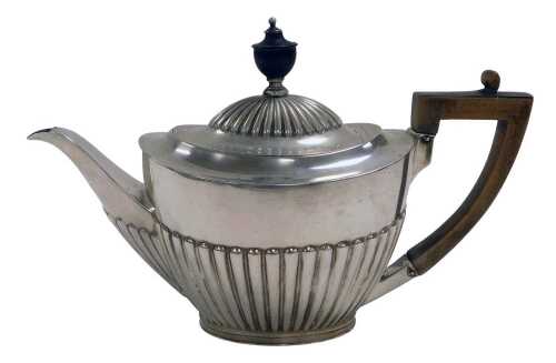 An Edward VII silver teapot, of semi fluted form, Goldsmiths & Silversmiths Company, London 1901,...