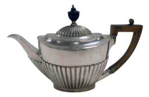 An Edward VII silver teapot, of semi fluted form, Goldsmiths & Silversmiths Company, London 1901,...