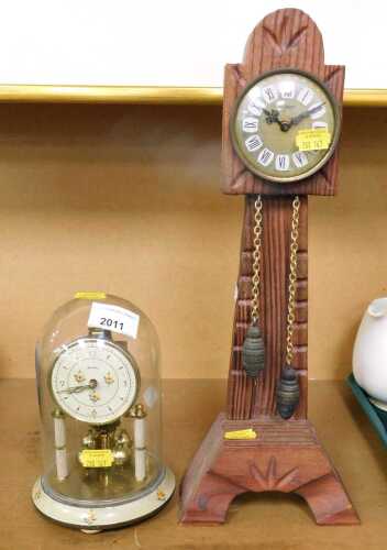 A pair of clocks, comprising a Bentima 400 day anniversary torsion clock, with a white floral...