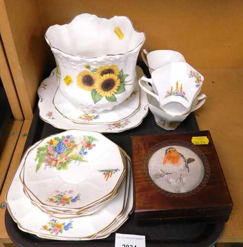 A part tea service, with a floral cottage scene and gilt edges with square shaped cups, together...