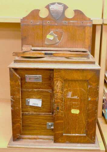 A turn of the 20thC oak smoker's cabinet, with a silver dedication plaque on top and a brass...