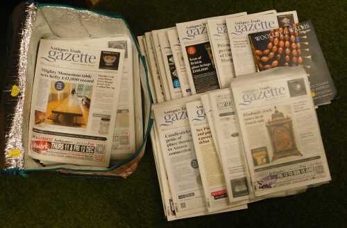 Various editions of the Antiques Trade Gazette, together with two Woolley and Wallis auction...