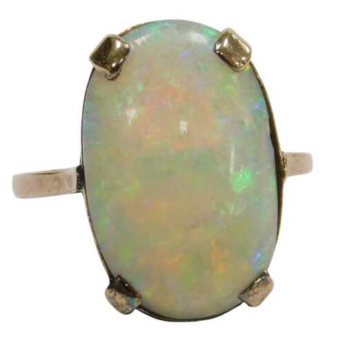 An opal ring, in an oval claw setting, in rose metal, unmarked, size M, 3.1g. (AF)